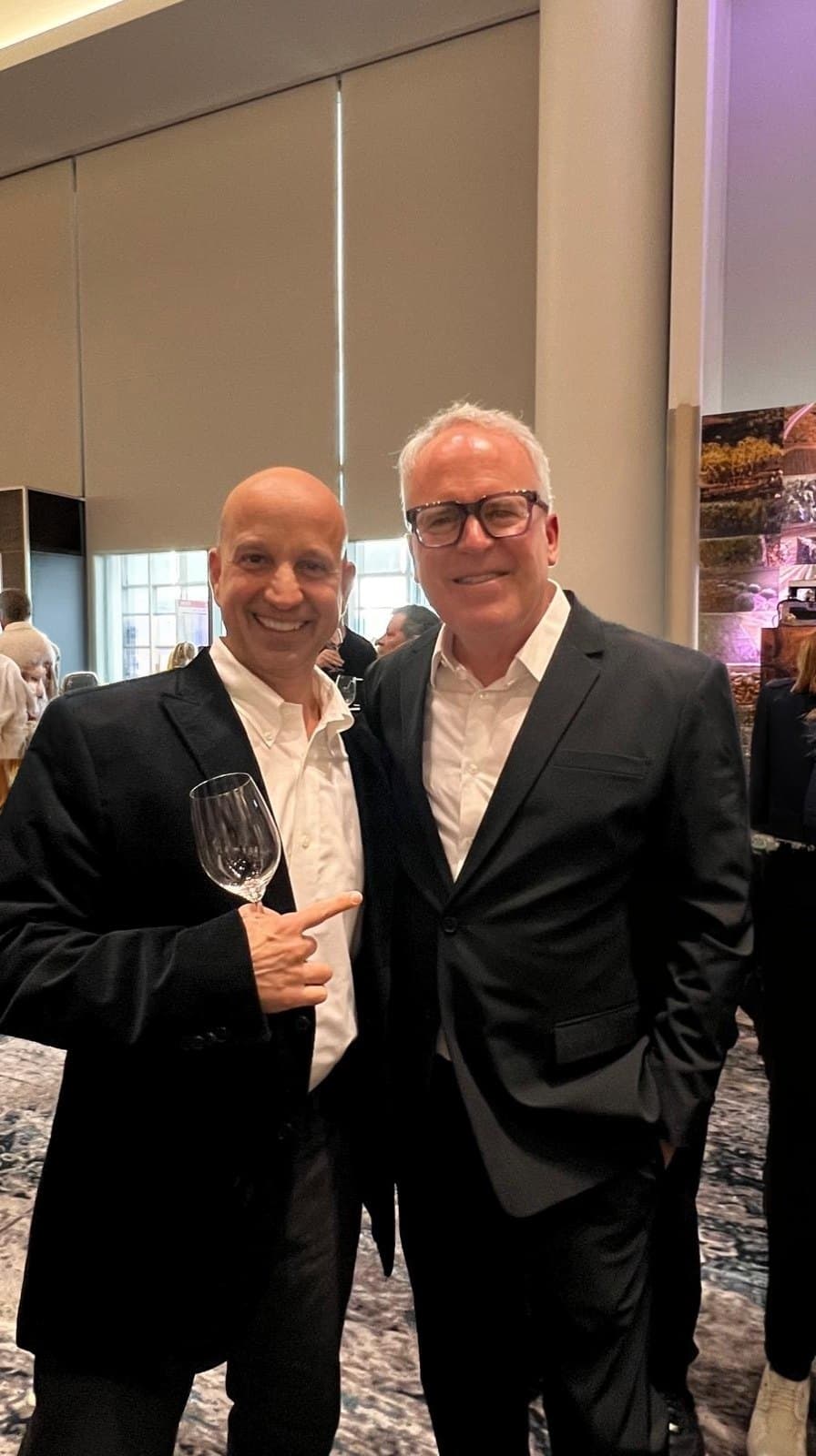 Gustavo standing with the wine critic James Suckling, both holding glasses