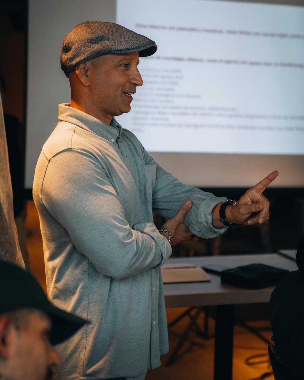 Gustavo Piteo leading a wine class, talking a room through a slide